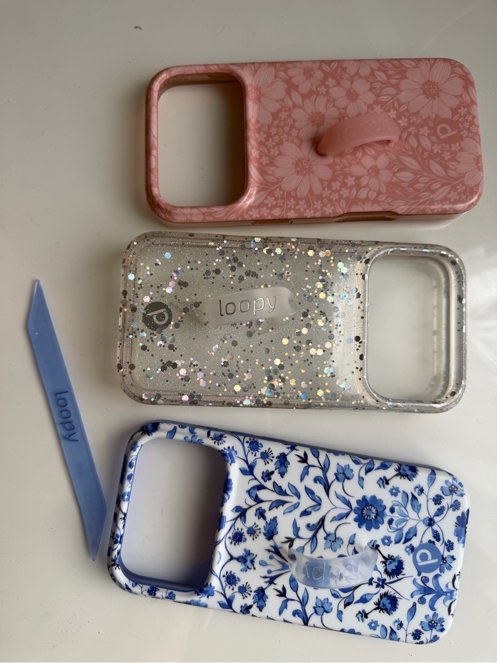 Iphone 17 pro Loopy Cases: Pink Floral, Clear Glitter & Blue Floral Phone Cases